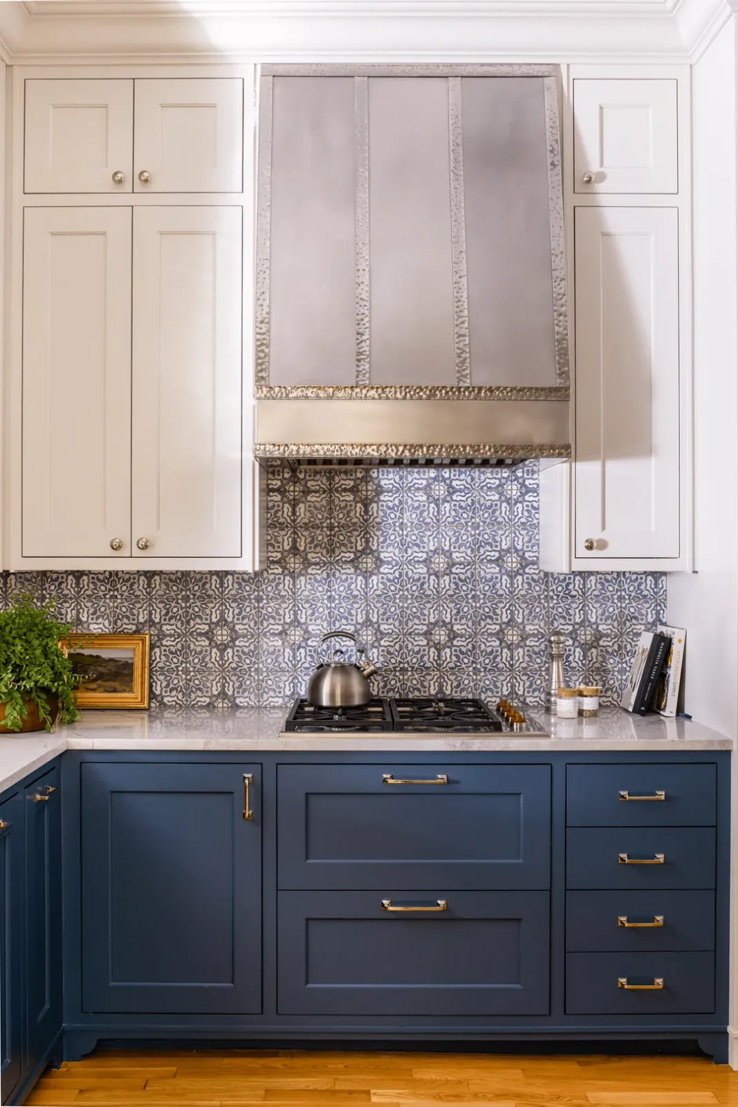 Kitchen tile backsplash with intricate blue and white patterns above navy cabinets