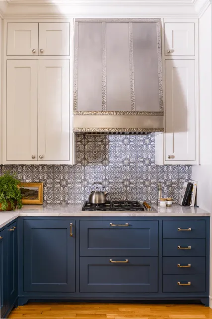 Kitchen tile backsplash with intricate blue and white patterns above navy cabinets