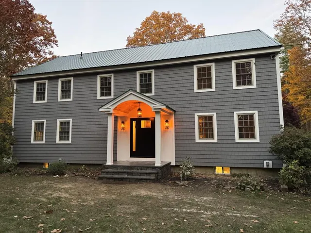 CertainTeed Cedar Impressions Charcoal Gray siding with black Harvey entry door installed in Raymond, NH