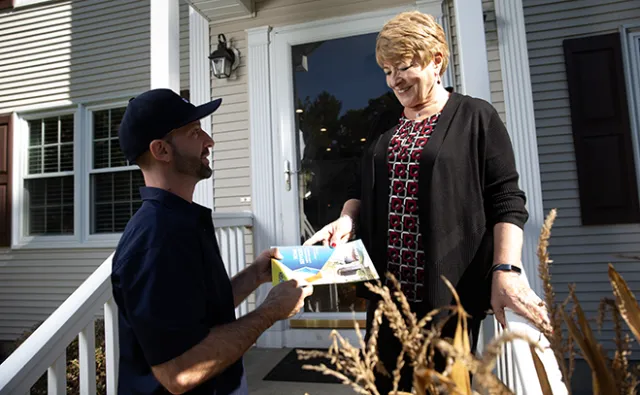 GEM technician explaining service options to homeowner