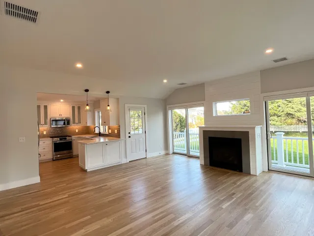 There is a fireplace in the middle of the living room