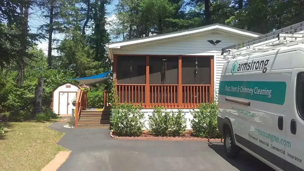 Technician cleaning a home's air ducts with professional vacuum equipment
