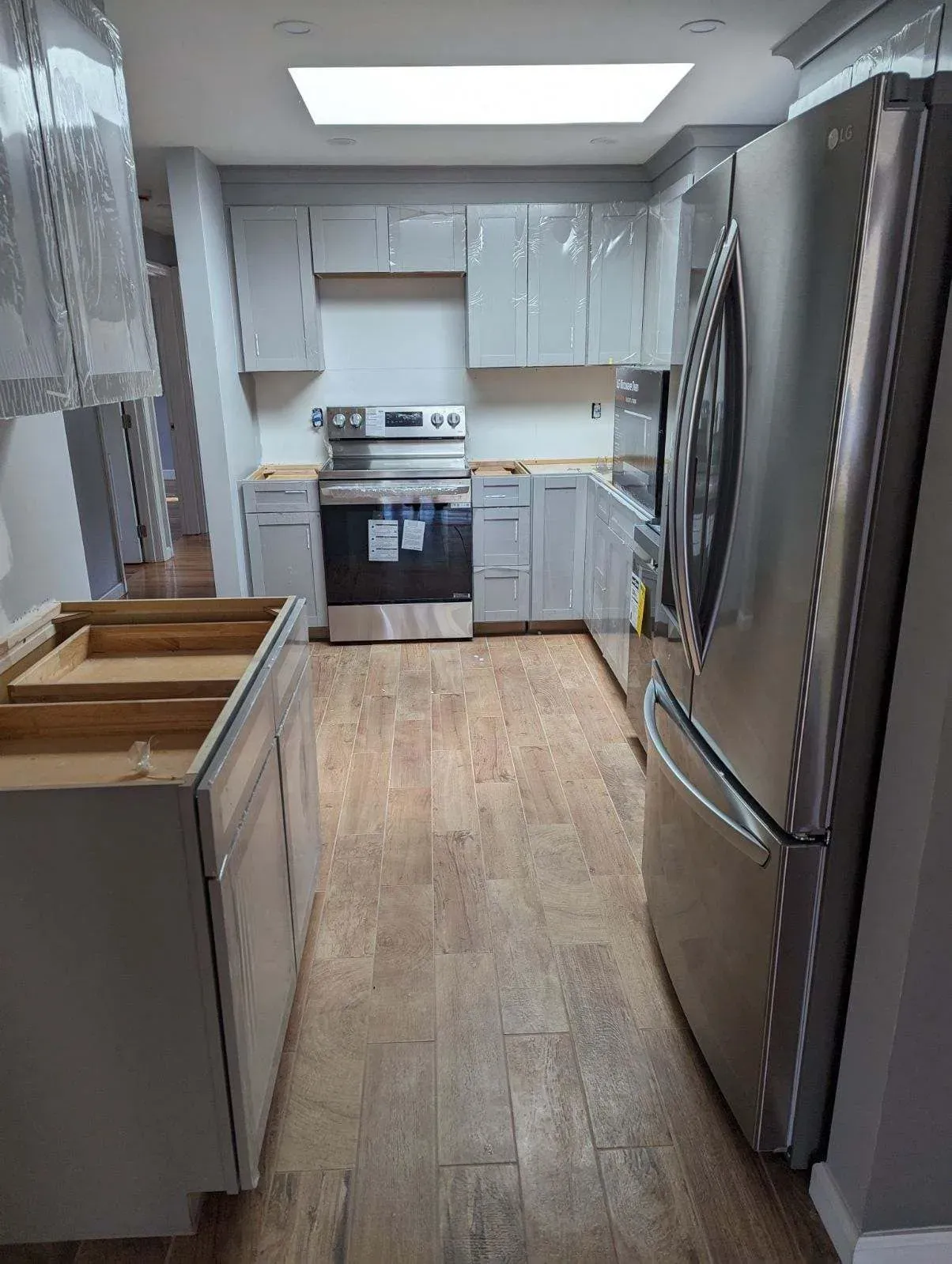A kitchen with stainless steel appliances and white cabinets.
