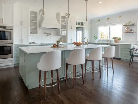 Wallingford kitchen with white and green cabinetry and Lincoln quartz countertops.