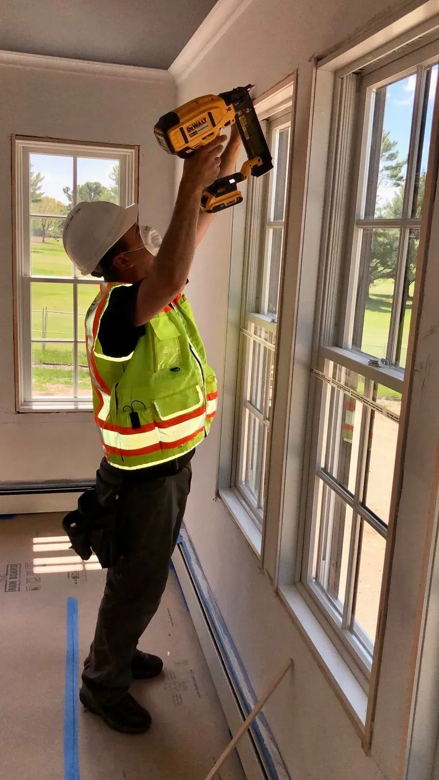 Contractor installing window framing on commercial project