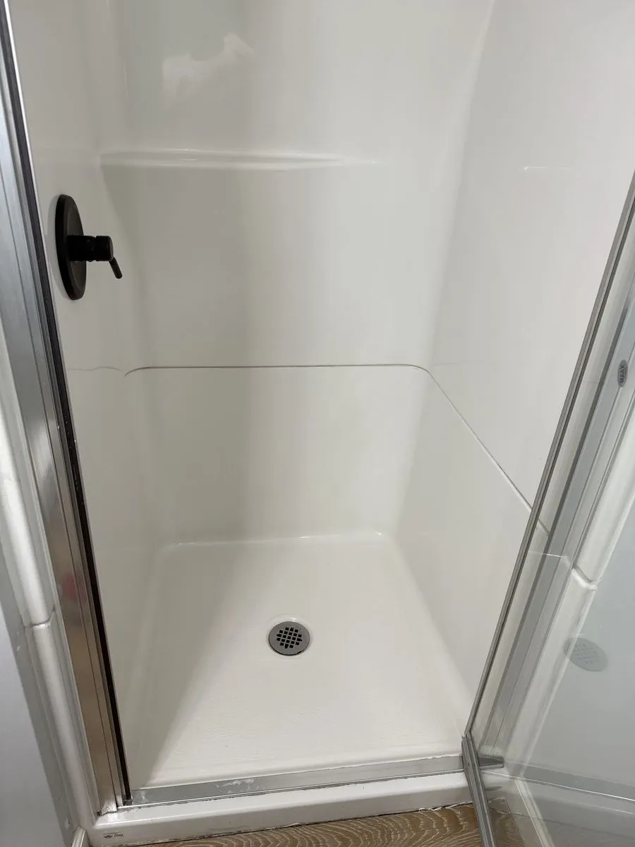 Bright white shower base after mold and buildup removal