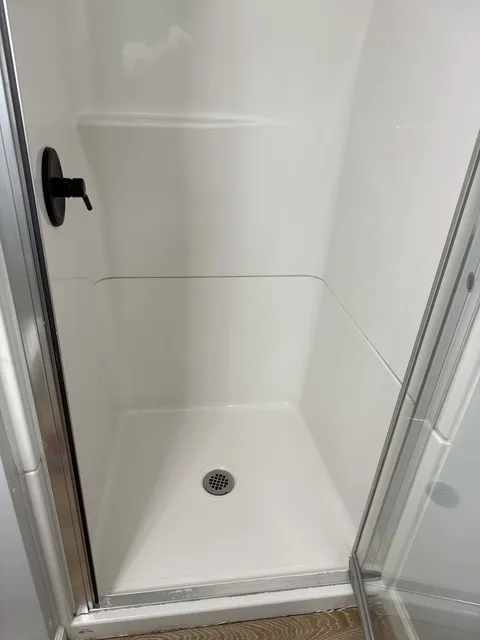 Bright white shower base after mold and buildup removal