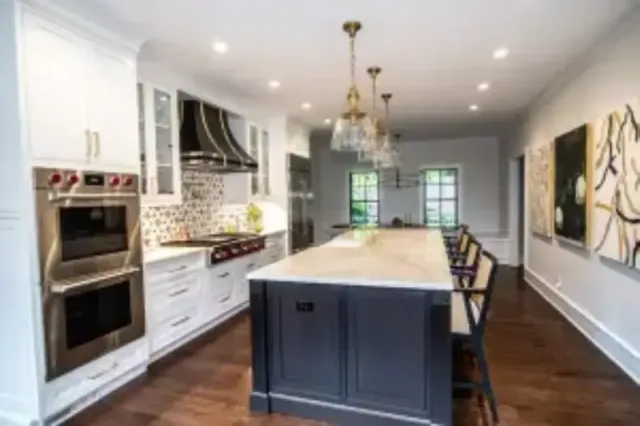 A modern eat-in kitchen with island seating and stainless steel appliances.