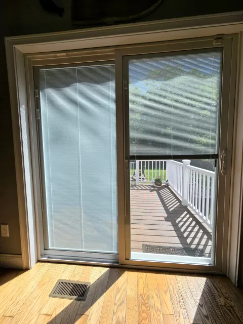 Sliding patio doors with vertical blinds in the glass.