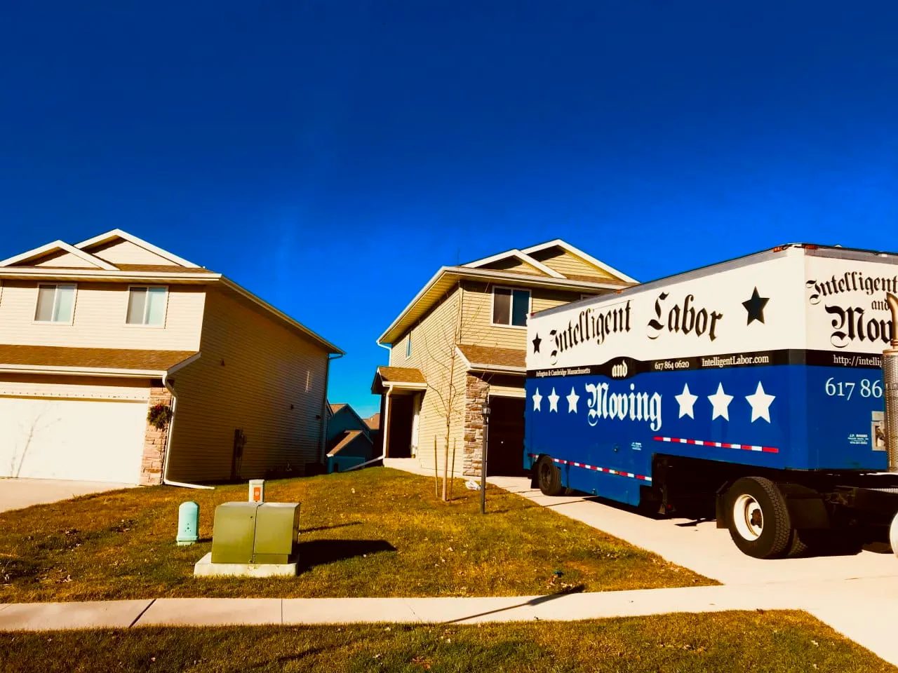 Moving trailer parked in a driveway ready to unload.