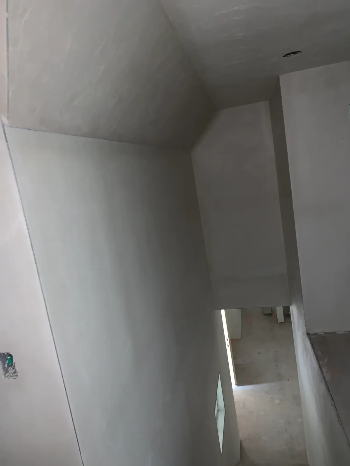 A person is walking down a set of stairs in a room.