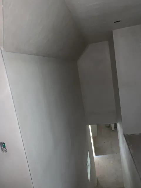 A person is walking down a set of stairs in a room.