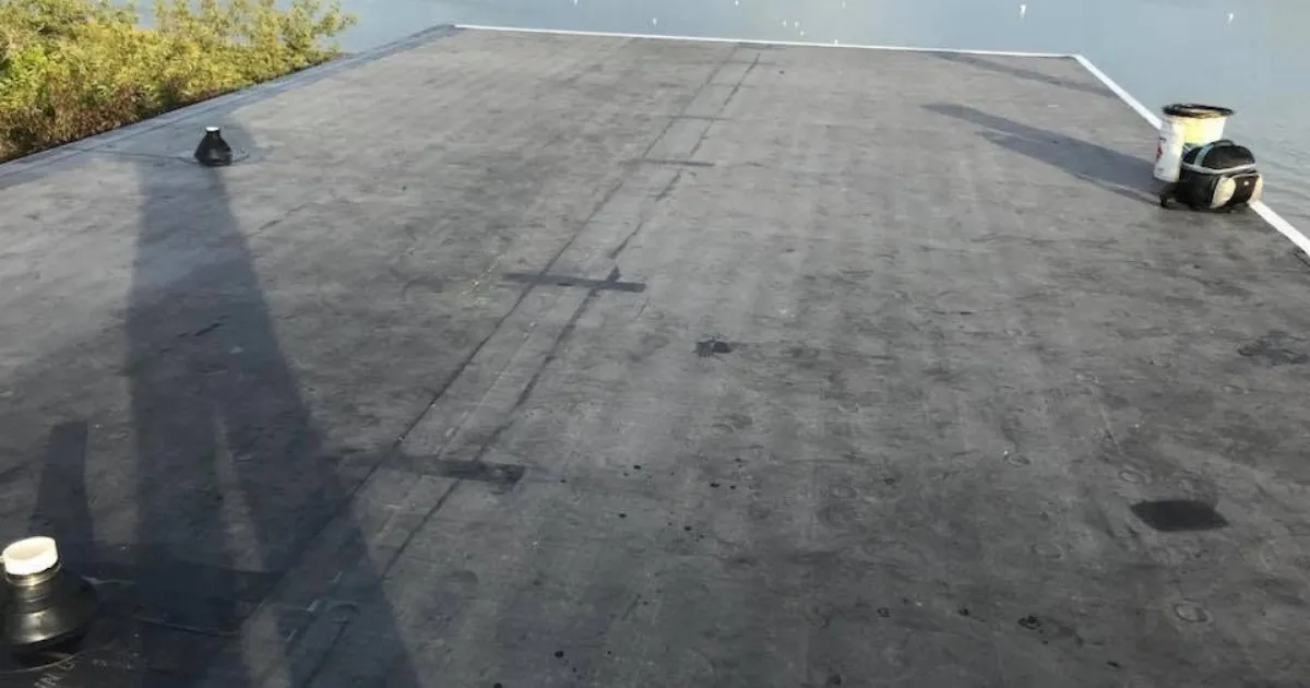 Completed EPDM rubber roofing installation on a waterfront property