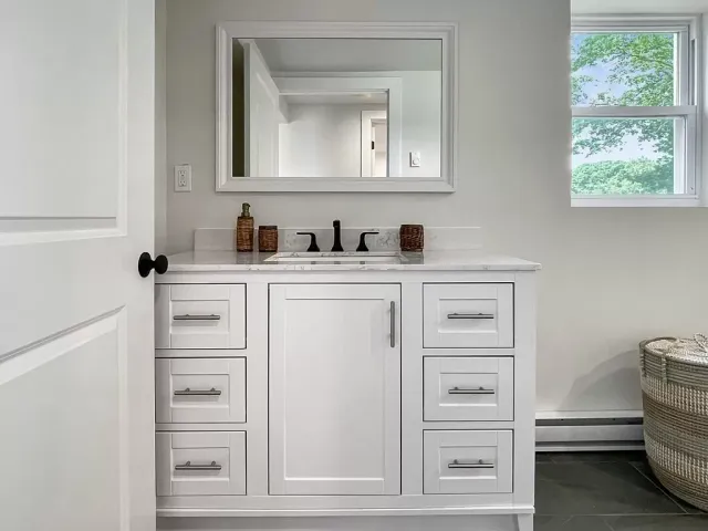 Double-door vanity and mirror in a remodeled bath