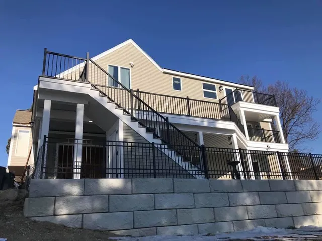 Exterior shot of new retaining wall and railings for a deck remodel