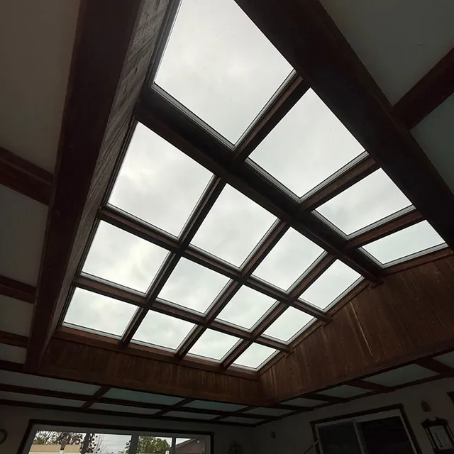 Wood-paneled ceiling with large rectangular skylights letting in daylight indoors