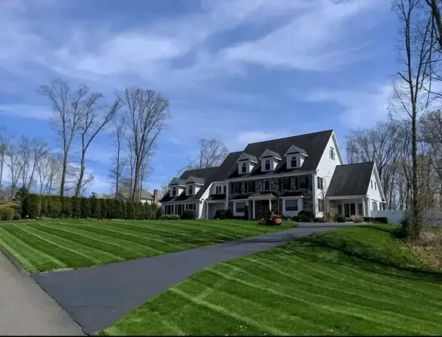 A large house with a lush green lawn in front of it.