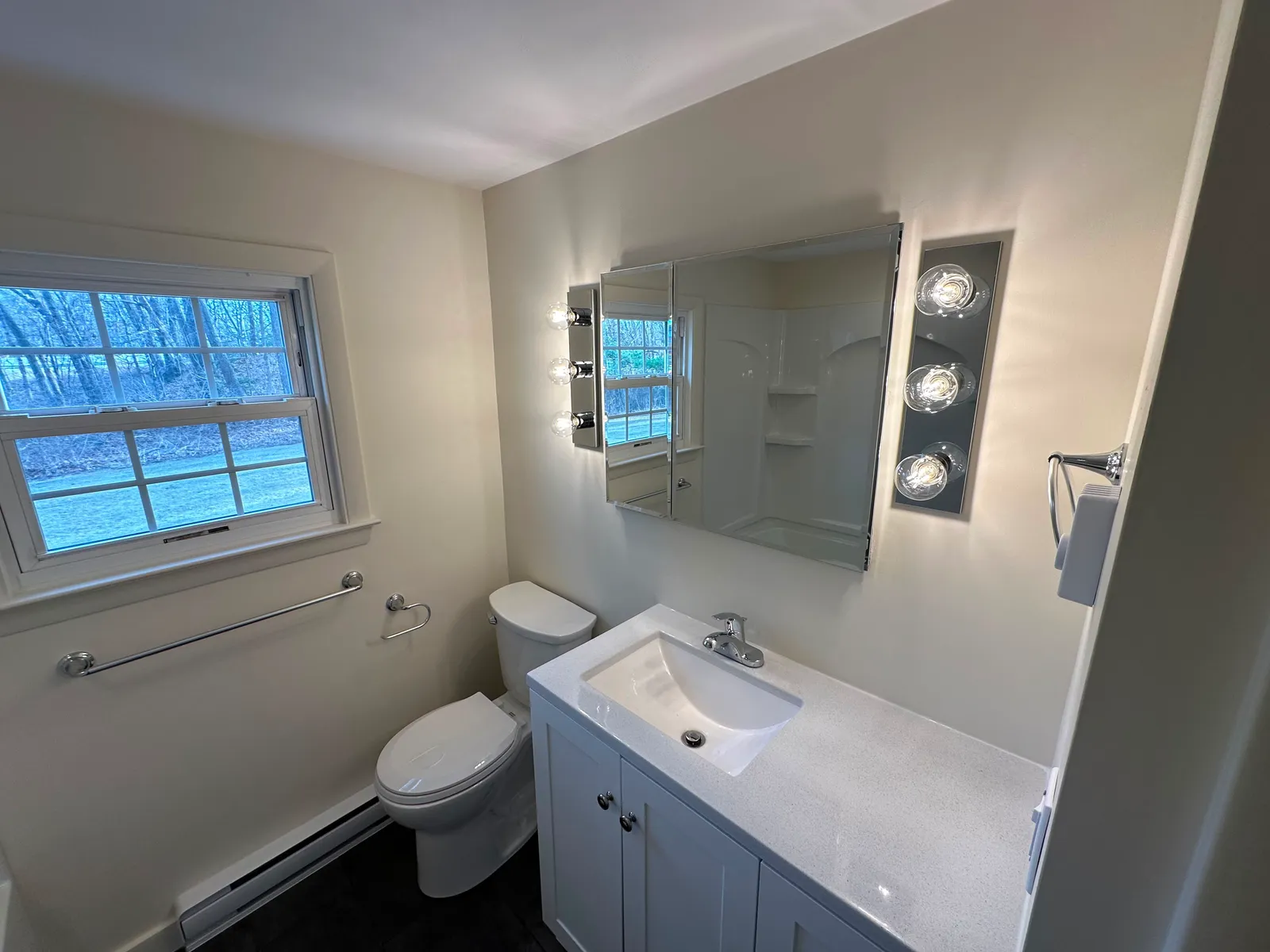 Freshly painted bathroom with neutral walls and trim in a Central MA home