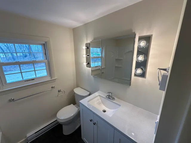 Freshly painted bathroom with neutral walls and trim in a Central MA home