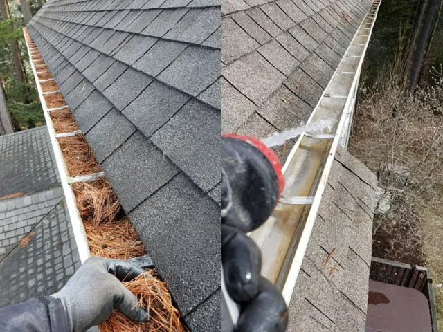 a person cleaning a  gutter on top of a roof