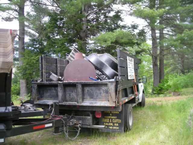 The Palmer Cleanouts & Disposal, LLC truck hauling away a load of junk