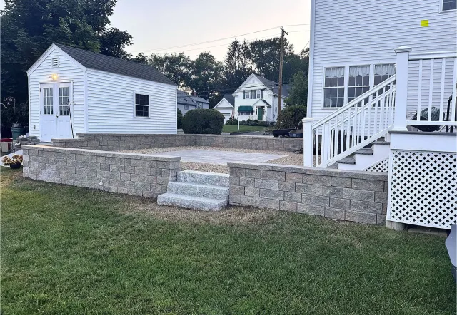 After: Stone retaining wall with patio steps
