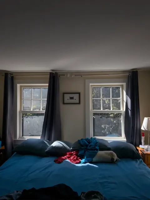 Before photo of a dusty double window in a bedroom