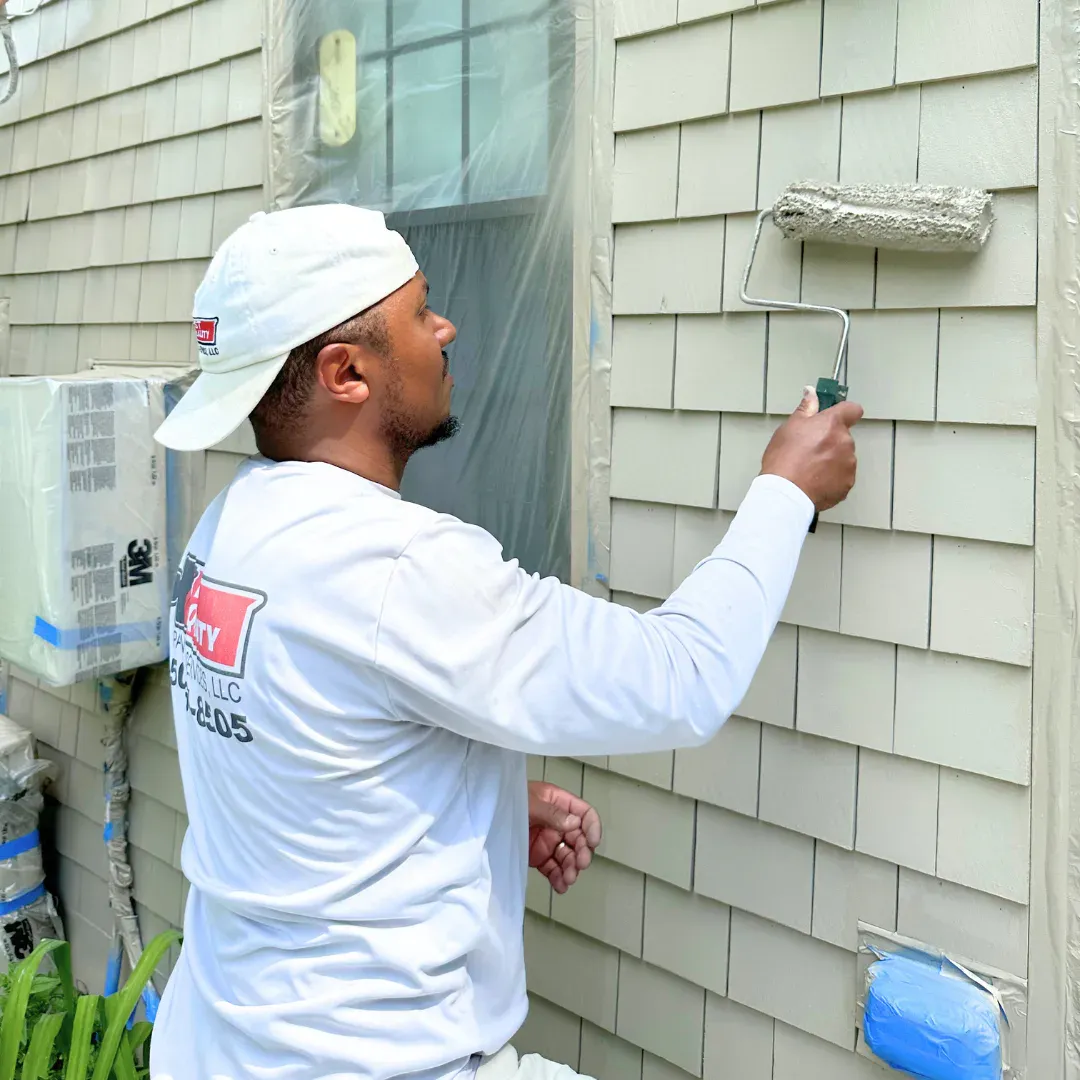 Exterior house painting project showcasing fresh coastal home siding and trim.