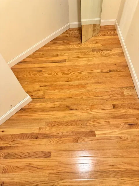 New hardwood flooring carried through a smaller Merrimack room