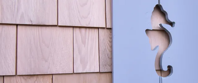 custom seahorse carved into window shutters