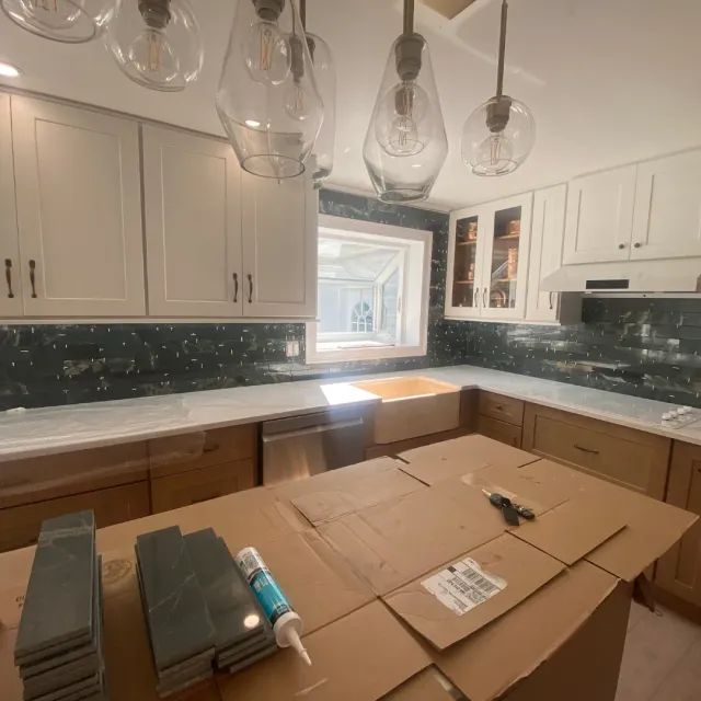 Two-tone kitchen renovation with walnut base cabinets, white uppers and emerald mosaic by SF Construction in Northborough, MA