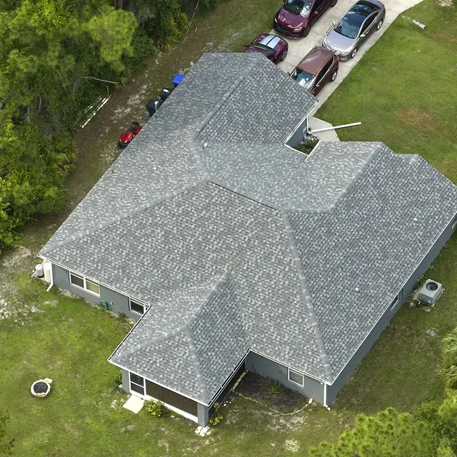 aerial view of the roof of a residential house, showing the surface, the material of the tiles, and the overall structure from an elevated perspective.