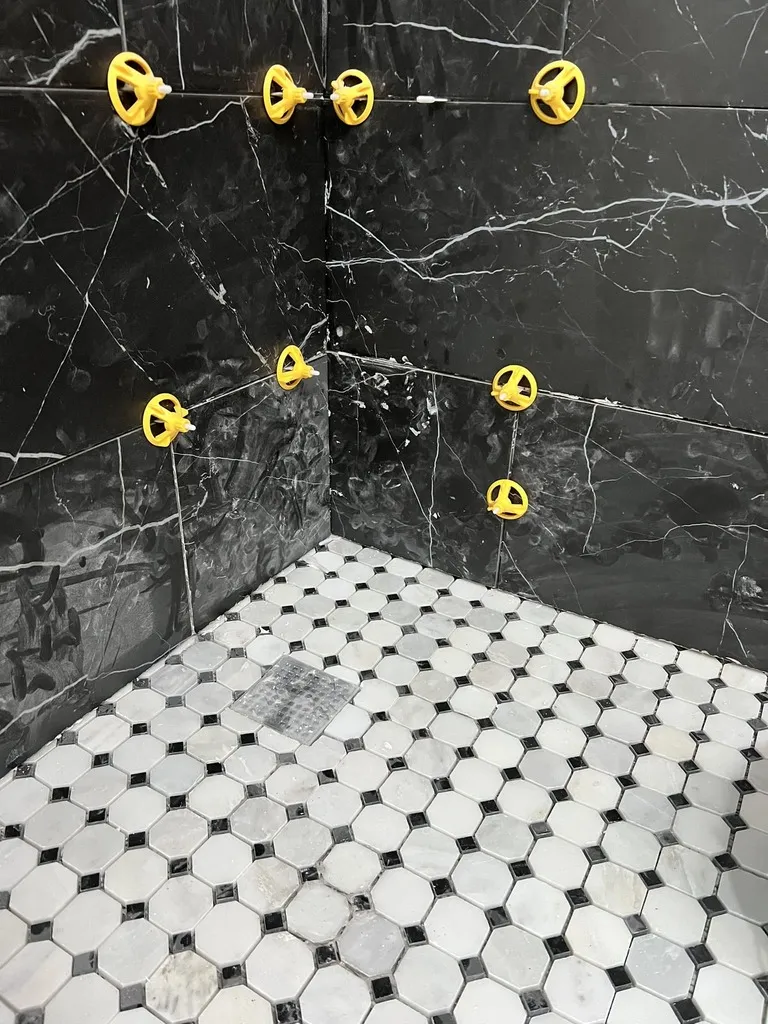 Classic Hexagonal Tile Floor with Black Marble Walls