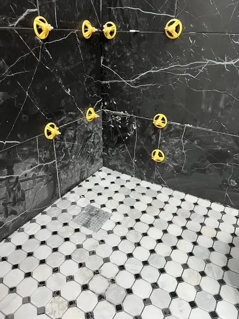 Classic Hexagonal Tile Floor with Black Marble Walls