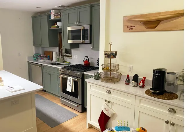 Custom kitchen with two-tone cabinetry and floating shelf