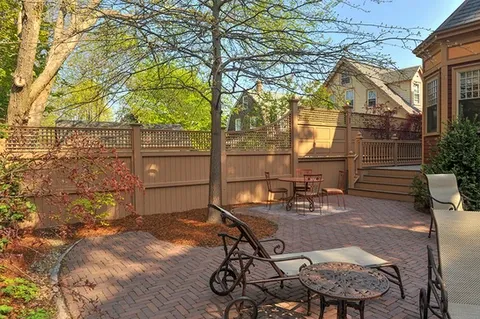 custom backyard fence with custom hard-scaped brick floor