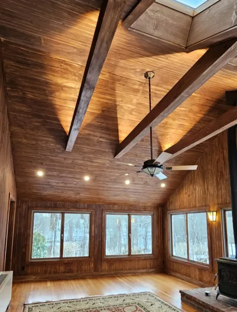 The finished vaulted wood ceiling and beams with a warm even stain throughout the room