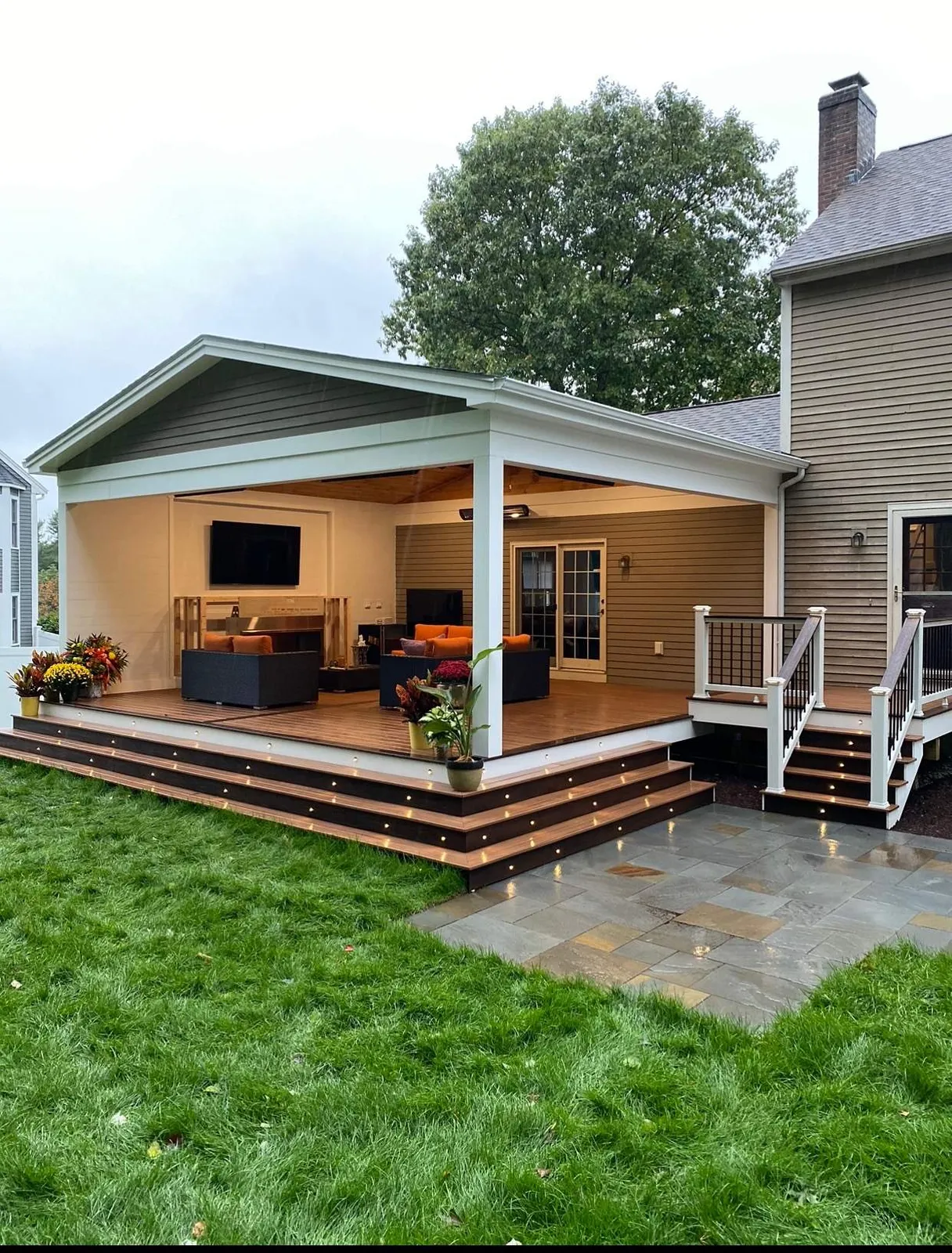 Covered deck with lights on stairs steps with outdoor living spaces in worcester ma