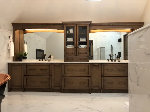 Haute Designs Kitchen & Bath. Kitchen. Elmwood Cabinetry with distressed finish. Freestanding copper bathtub. Oil-rubbed hardware & fixtures. Porcelain tiles with marble look. Shower features: rain shower head, niche. Strip lighting
