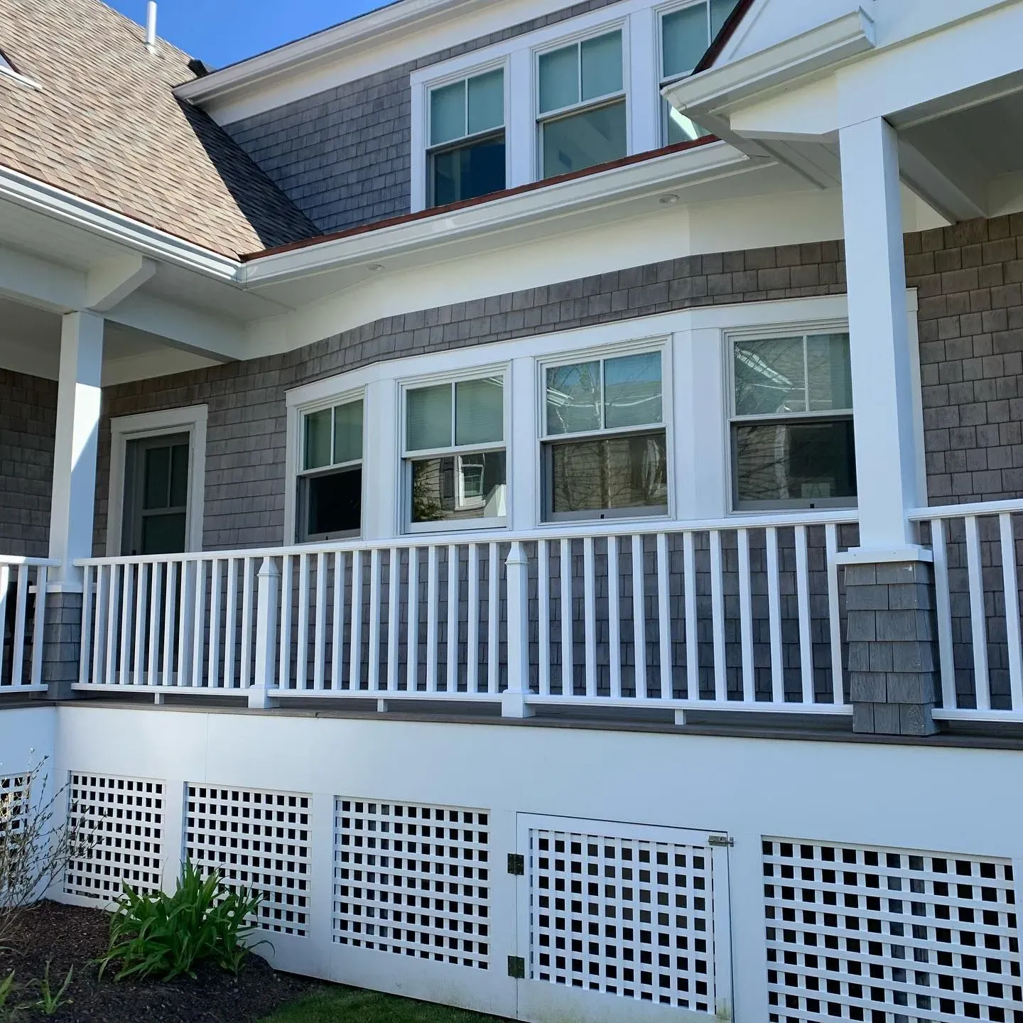 Porch view with clean windows and white railings at Cape Cod property