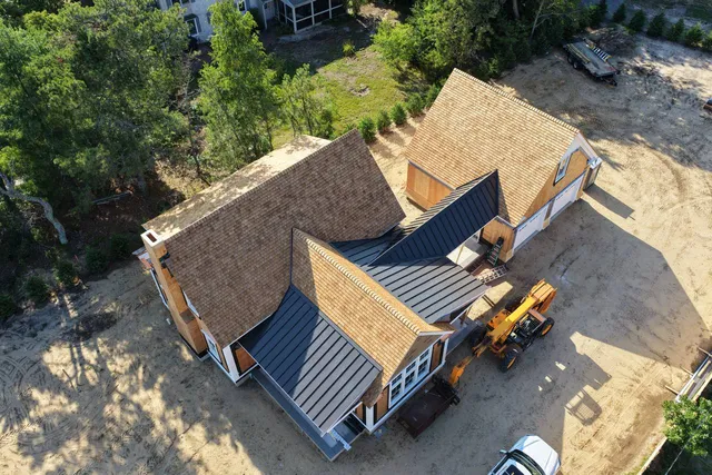 Completed roof sections above the coastal construction site