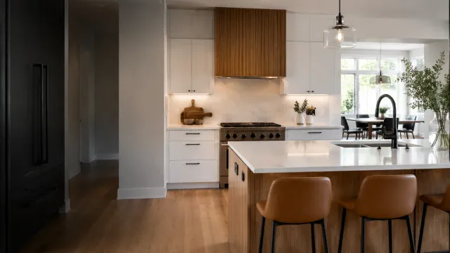 Newly remodeled modern kitchen with white cabinets and natural wood accents