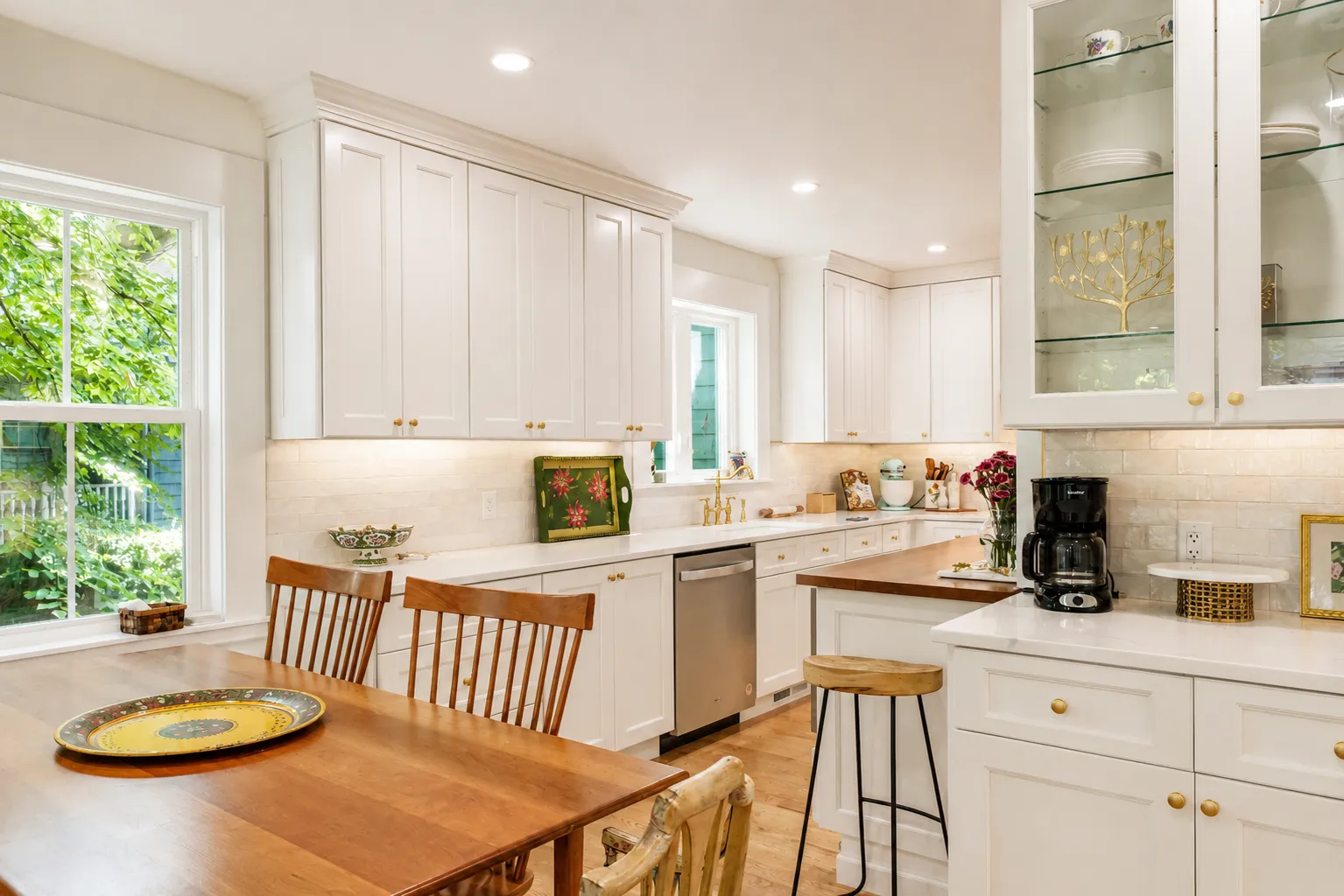 Cambridge kitchen remodel — white shaker cabinetry and glass upper cabinets