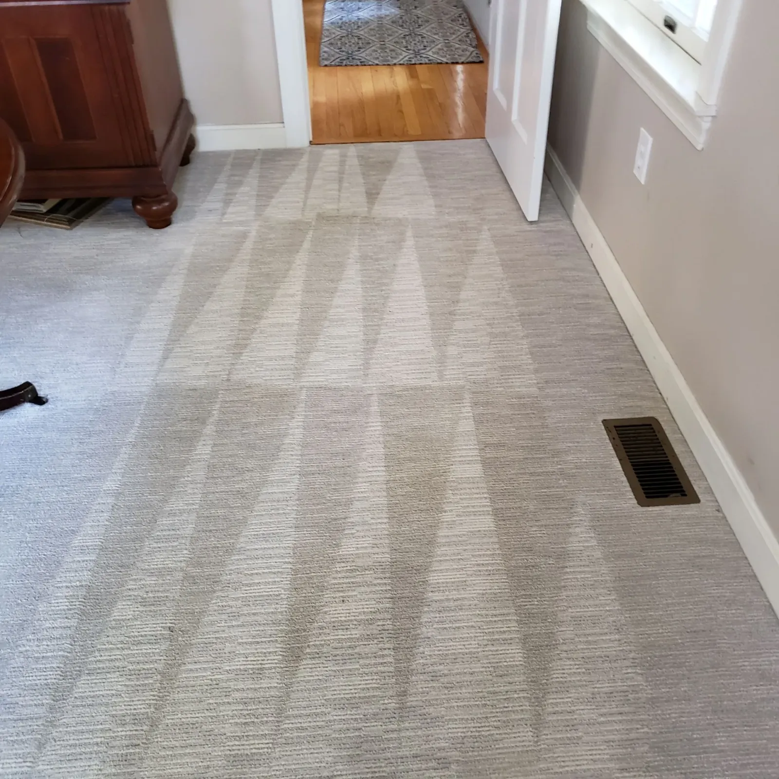 a room with a carpeted floor and a window