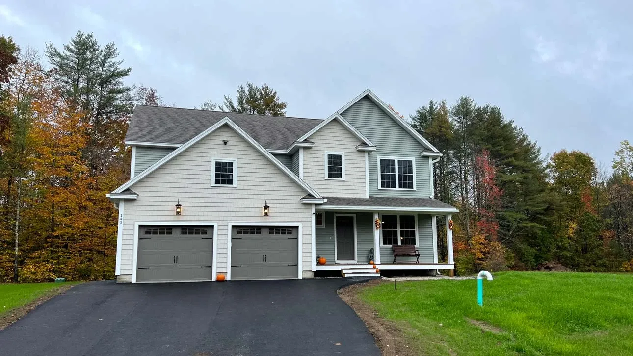 Front of gray house with new driveway