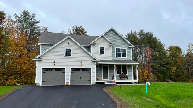 Front of gray house with new driveway