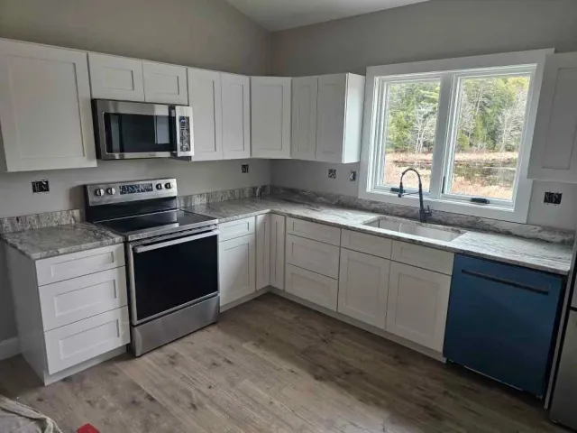 Fantasy Brown granite countertops installed in a white kitchen in Loudon, NH by Precision Granite Works