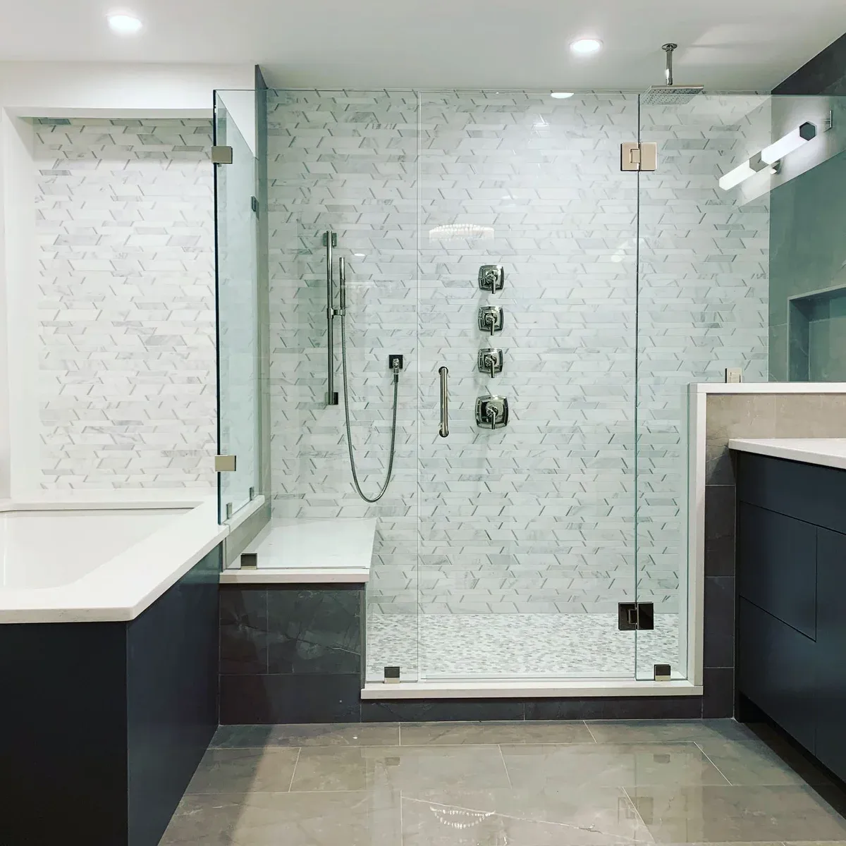 Renovated bathroom with marble tile and glass shower