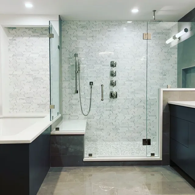 Renovated bathroom with marble tile and glass shower