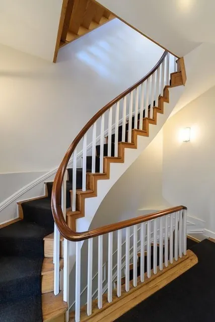 Curved staircase with new handrail and millwork